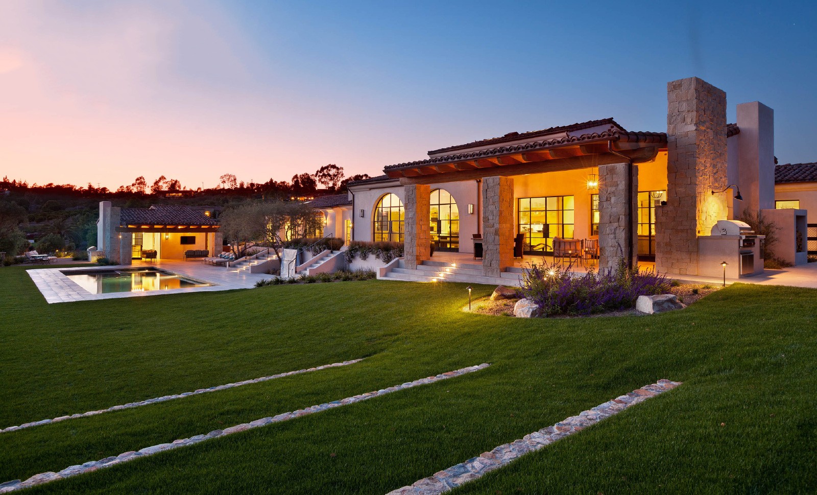 House at sunset featuring Portella windows and doors.