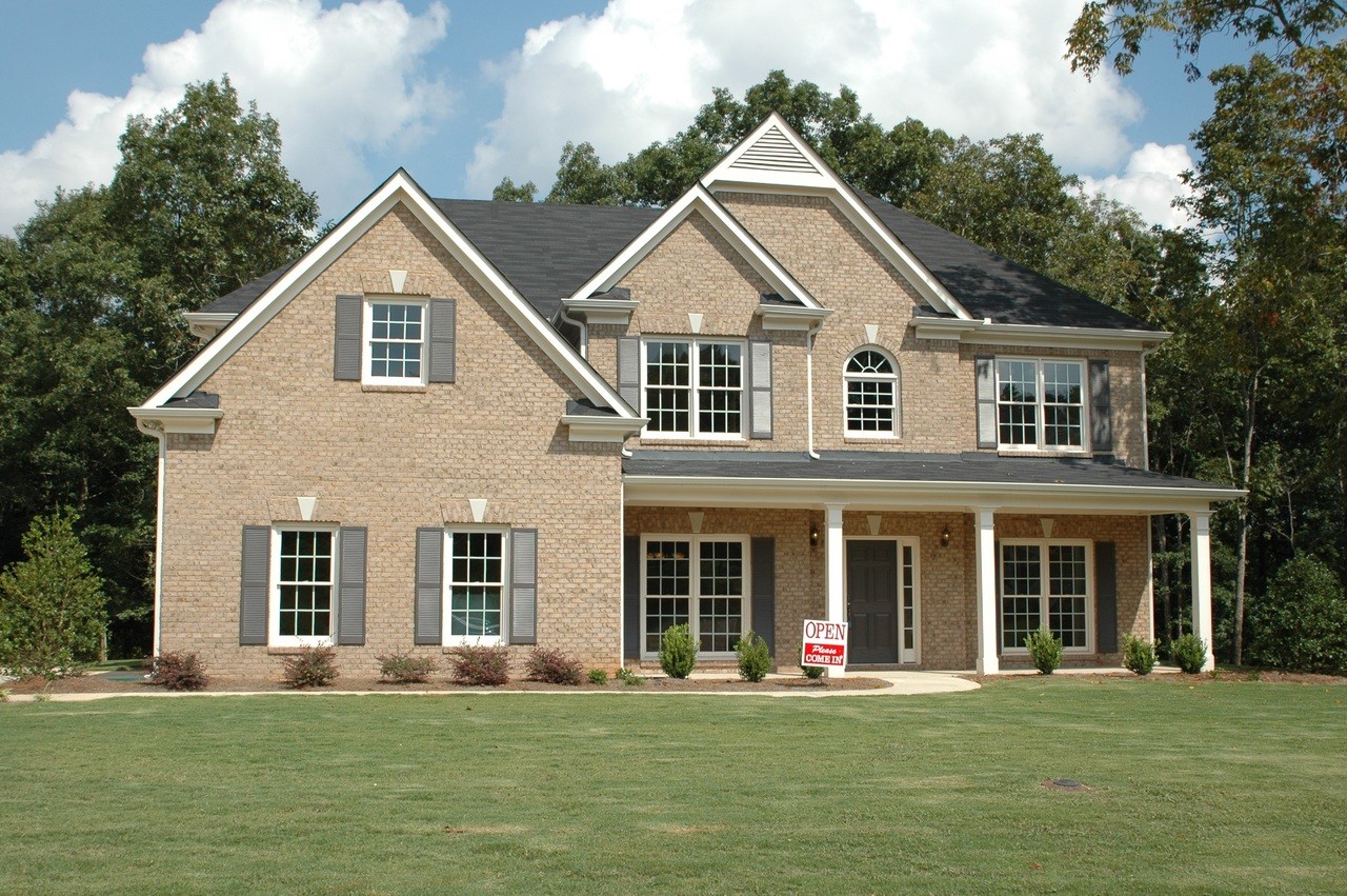 Image of a home with a For Sale sign in the yard