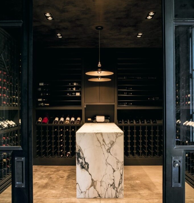 Image of wine wall, complete with racks and a glass door to keep the temp consistent